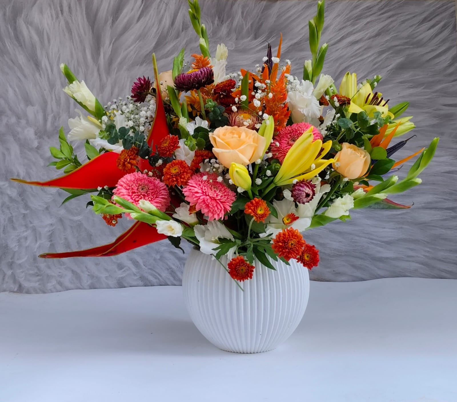Custom floral bouquet featuring snapdragons, orchids, and fillers.