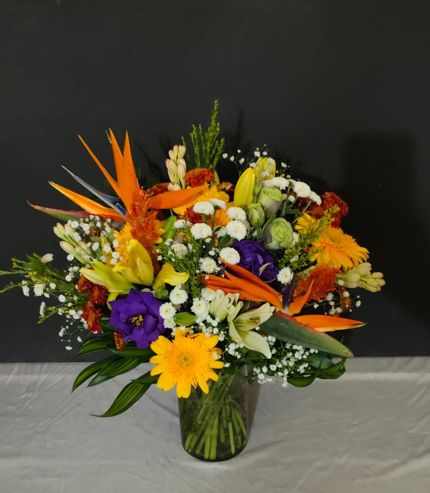 Rare exotic flowers arranged in a designer vase for upscale living spaces.