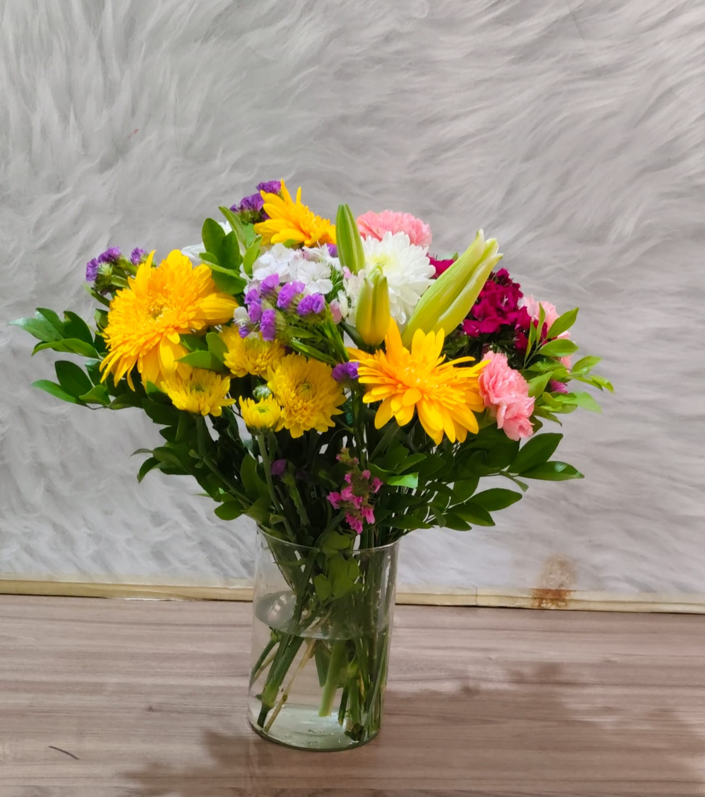 Buds and Blooms' Everyday Bloom subscription box with 5–7 fresh seasonal flower stems including marigolds, chrysanthemums, and gerbera, ready for weekly delivery