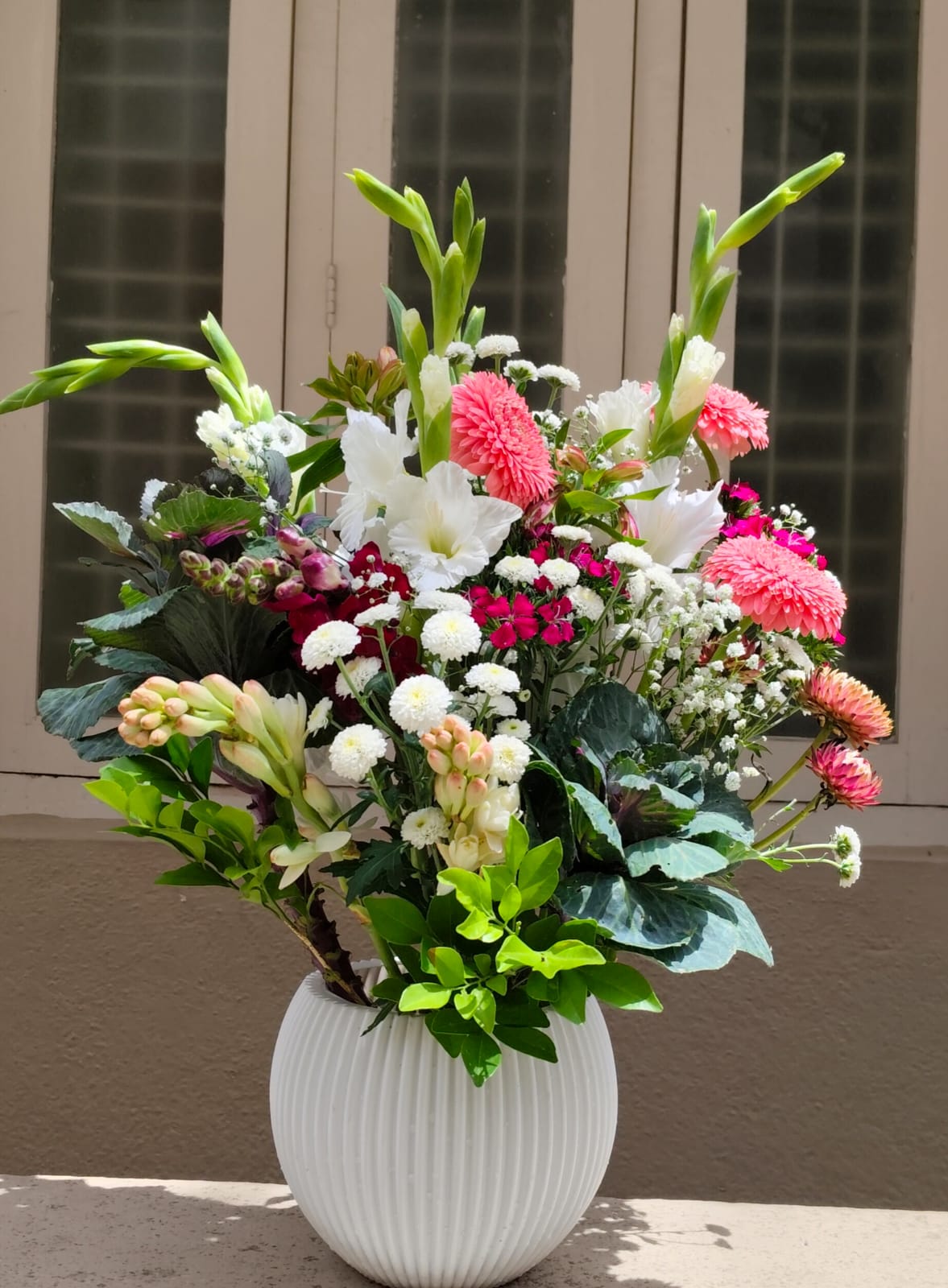 Elegant flower arrangement featuring exotic blooms in a sleek office reception area