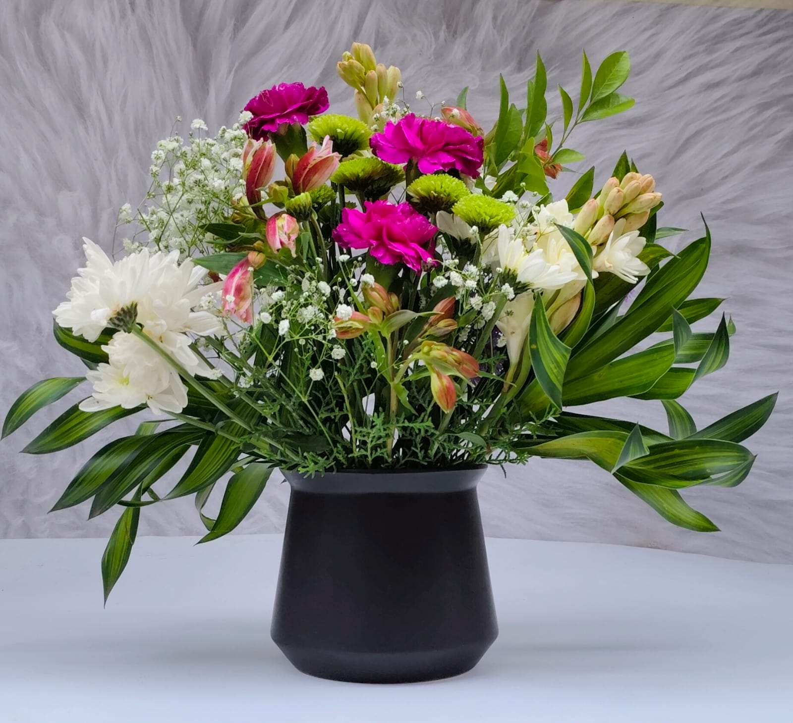 Handpicked seasonal blooms including roses, gerbera, and carnations, neatly wrapped with eco-friendly packaging, ready for delivery from Buds and Blooms
